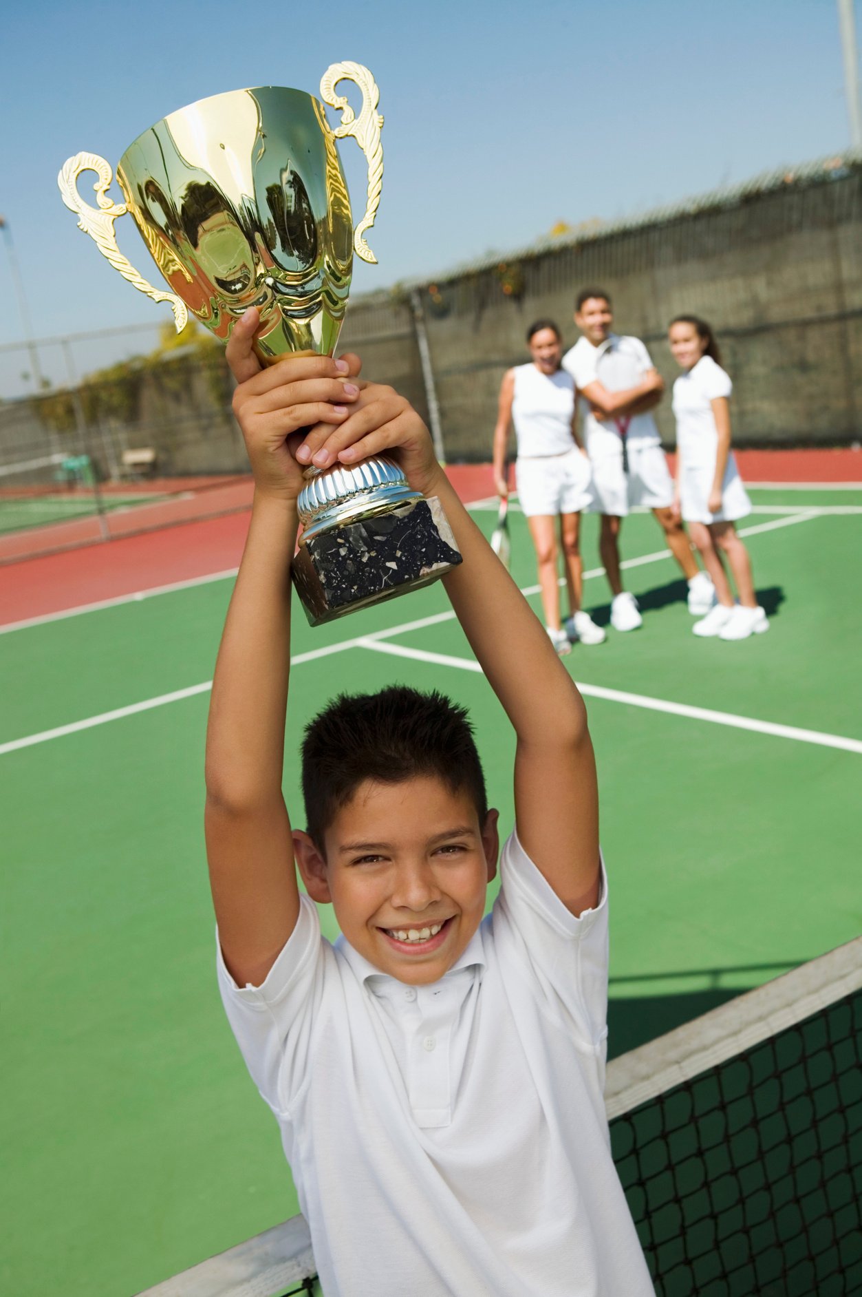 Boy Holding Tennis Trophy